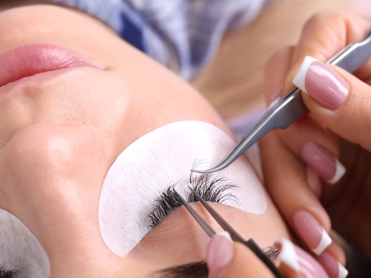 Close-up of a woman’s eye with lash extensions, questioning if lash extensions damage natural lashes
